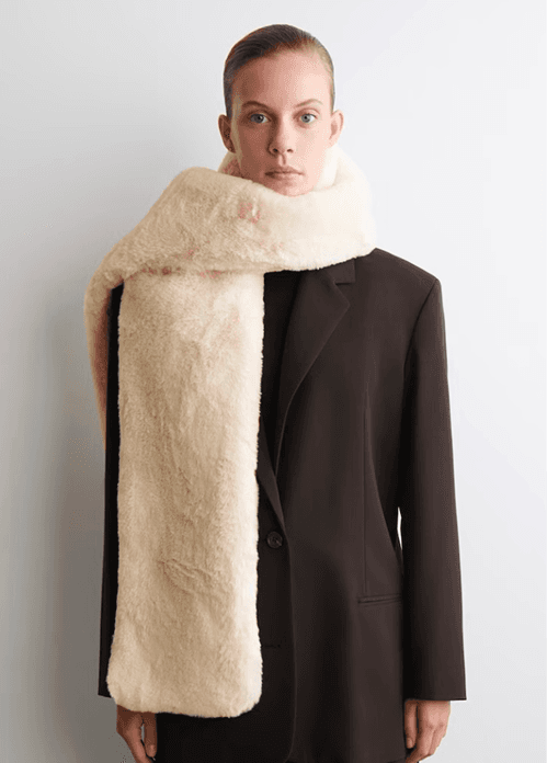Model wearing a cream wool cashmere scarf